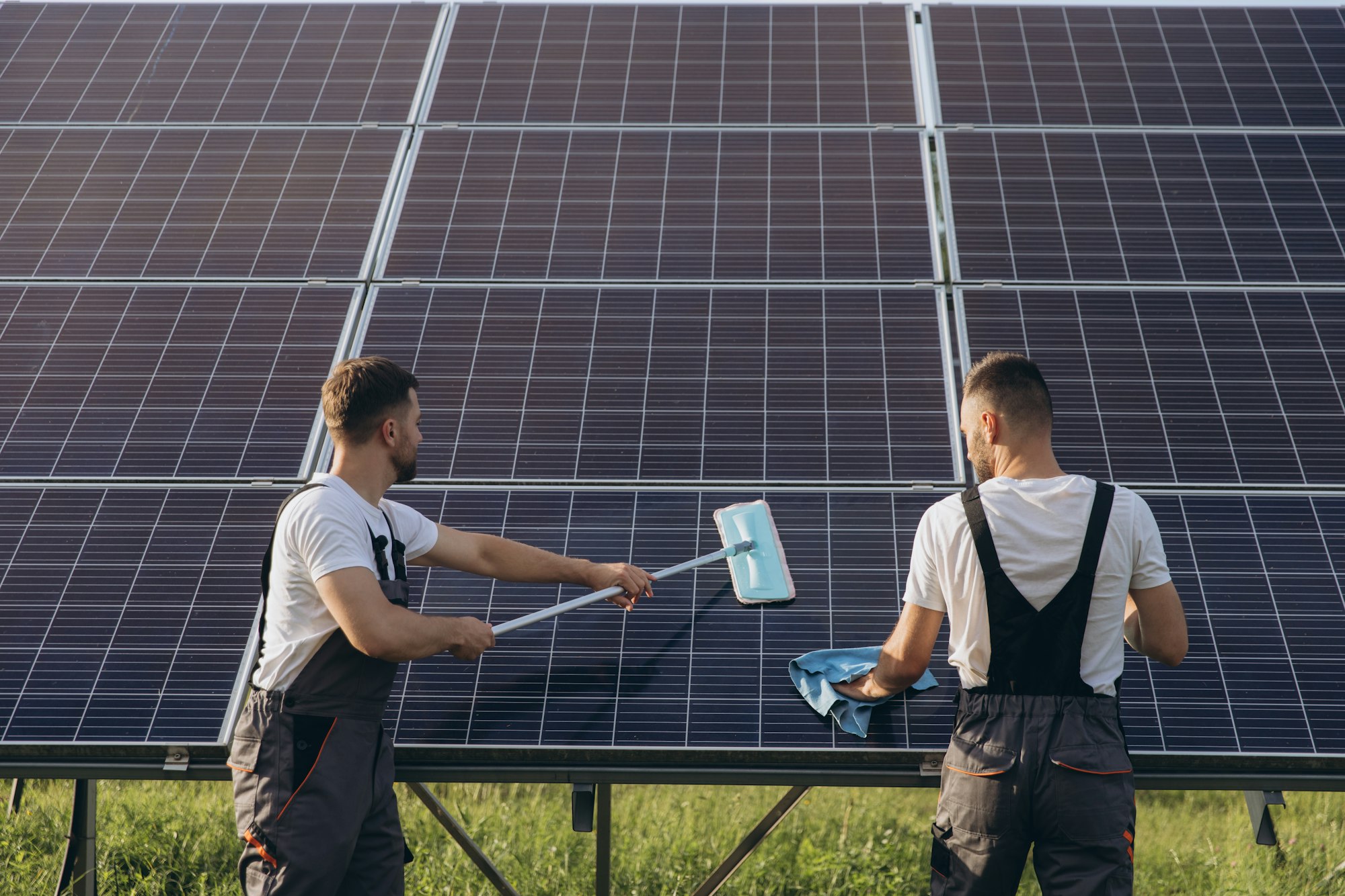 Labor working on cleaning solar panel at solar power plant, Professional cleaning, Solar panels.