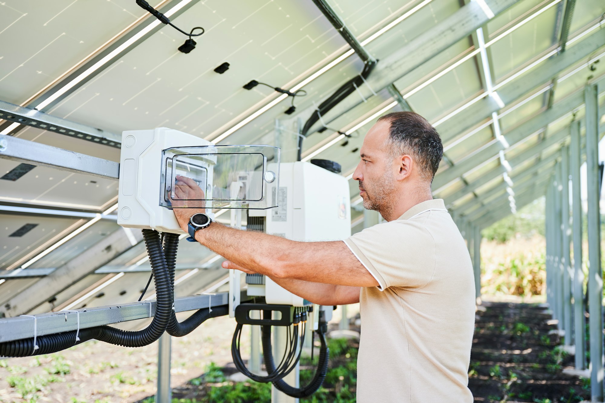 Young male turning on solar panel.